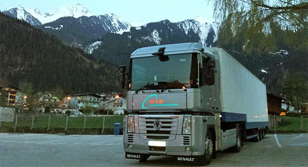 Silver ETS artic parked in front of snow-capped mountains in Austria