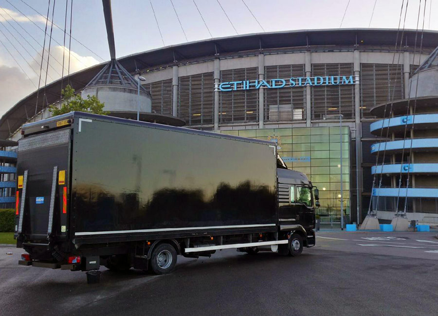 Black ETS box truck with a tail lift outside the Etihad Stadium in Manchester